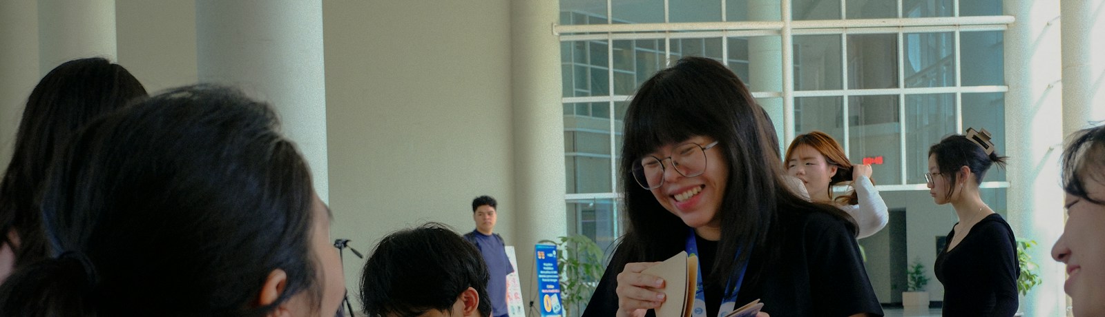Attendees checking in with event lanyards at a conference registration area