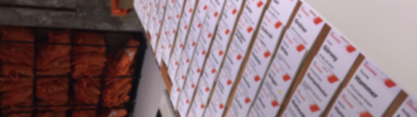 Rows of pre-printed event name badges laid out ready for collection at registration