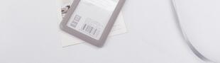 Blank ID badge holder with barcode on a lanyard, ready for onsite printing at an exhibition or conference