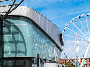 Delegates arriving at a large UK exhibition hall with accredited event access
