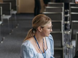 Two conference delegates in conversation wearing printed name badges on lanyards